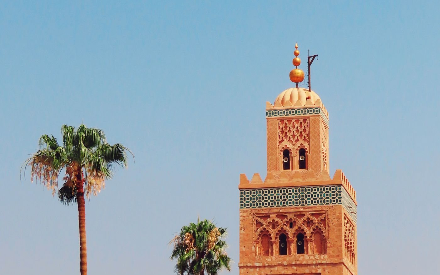 The Koutoubia Mosque minaret and palm trees in Marrakech